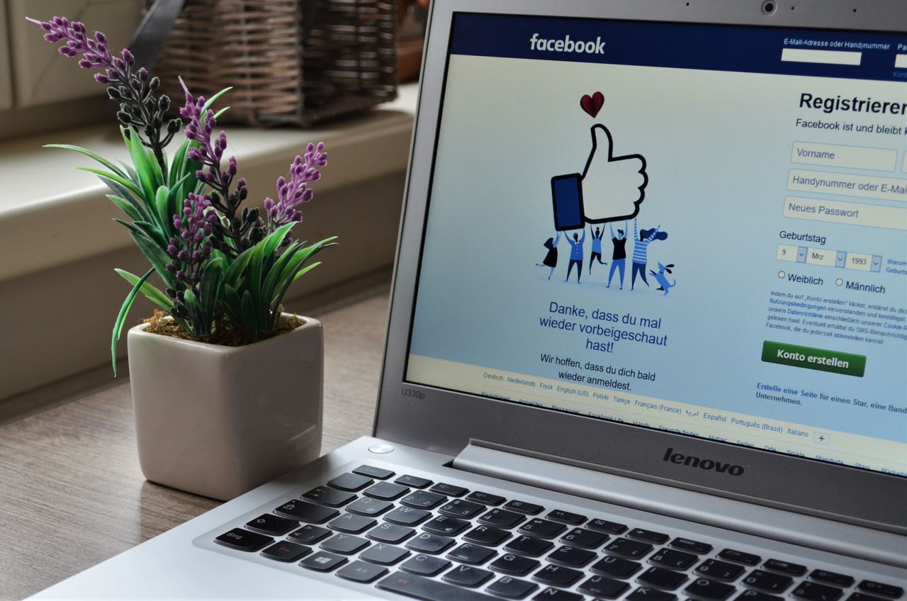 our-story A Lenovo laptop showing the Facebook login page next to an indoor lavender plant.